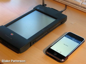 An Apple Newton next to an Apple iPhone.