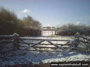 A wooden gate in winter snow