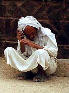 A man using a cellphone in a street in Iraq