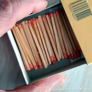 Photo of matches lying in a matchbox.