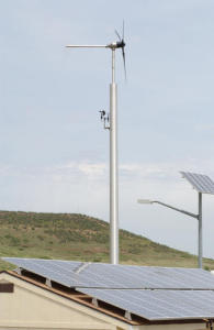 Micro wind turbine next to a solar powered house.