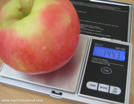 An apple weighed on a precise electronic balance.