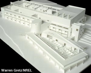 Architectural model of a building made from white cardboard.