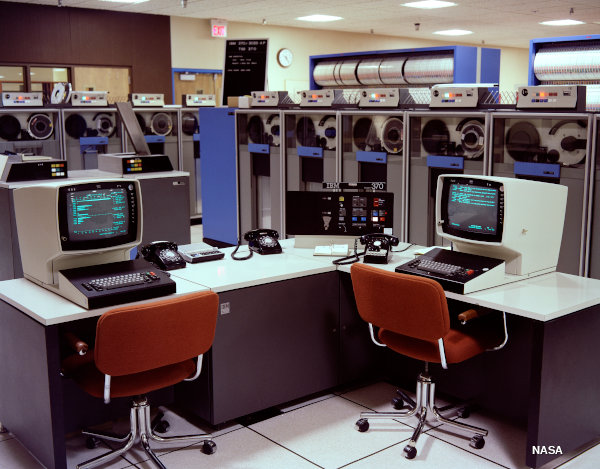 An IBM System/370 mainframe computer with tape drives in the background.