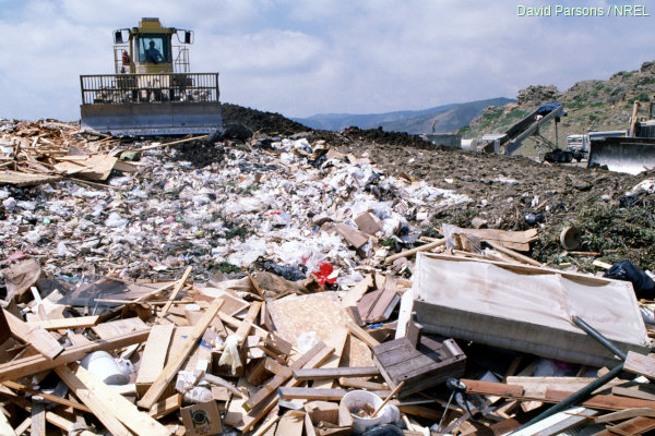 landfill site with garbage and a bulldozer