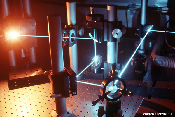 Laser beams follow precise paths between mirrors in a laboratory experiment.