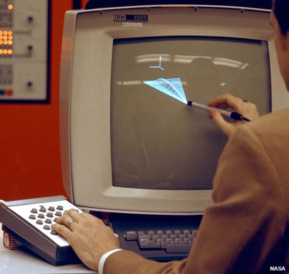 A NASA scientist draws a computer graphic image on a screen with a light pen