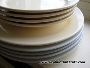 A stack of cream-colored porcelain dinner plates