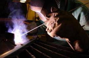 Welding metals with a Tungsten Inert Gas (TIG) welder.