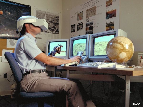 A NASA Ames scientist explores Mars using a virtual reality headset, data glove, and desktop controller.