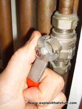 A stop valve being operated by hand.